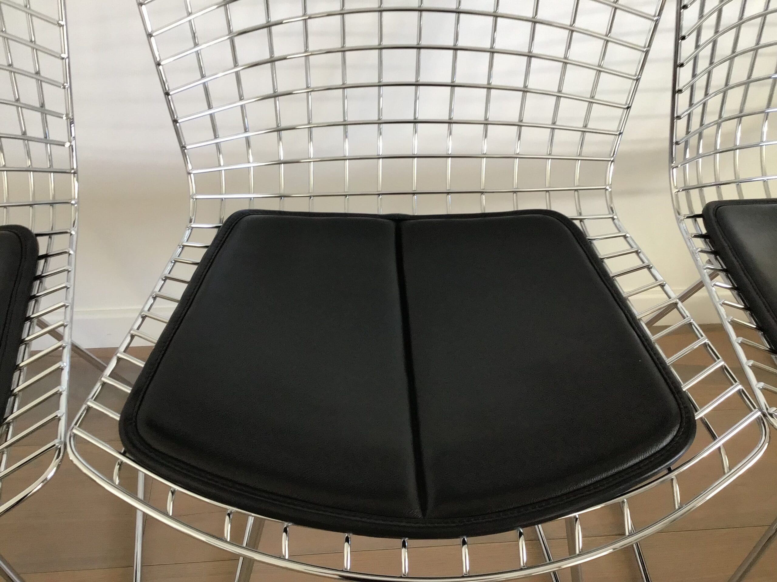 Lot de 4 chaises Bertoia chromées avec galette cuir noir – Design mid-century
